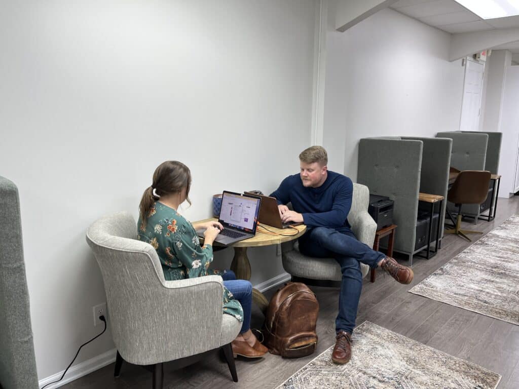 Two people working at a coworking shared office space.