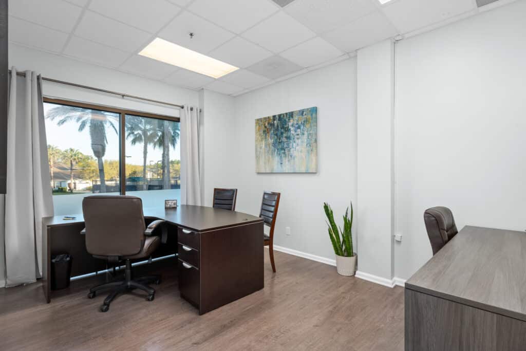 rent shared team office space in St Augustine with large windows that let in lots of natural light and seating for up to 5 people